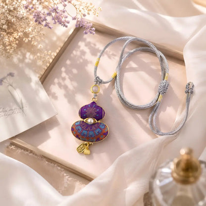 Purple Song Brocade gourd pendant shown flat with a handwoven cord
