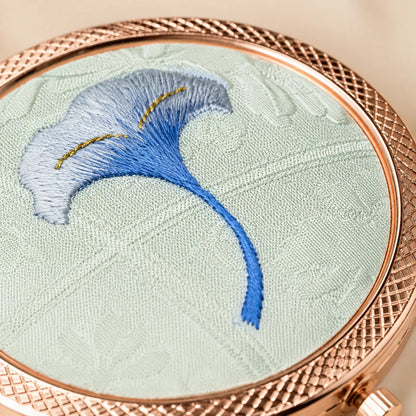 Close-up of blue ginkgo embroidery on the silk compact mirror