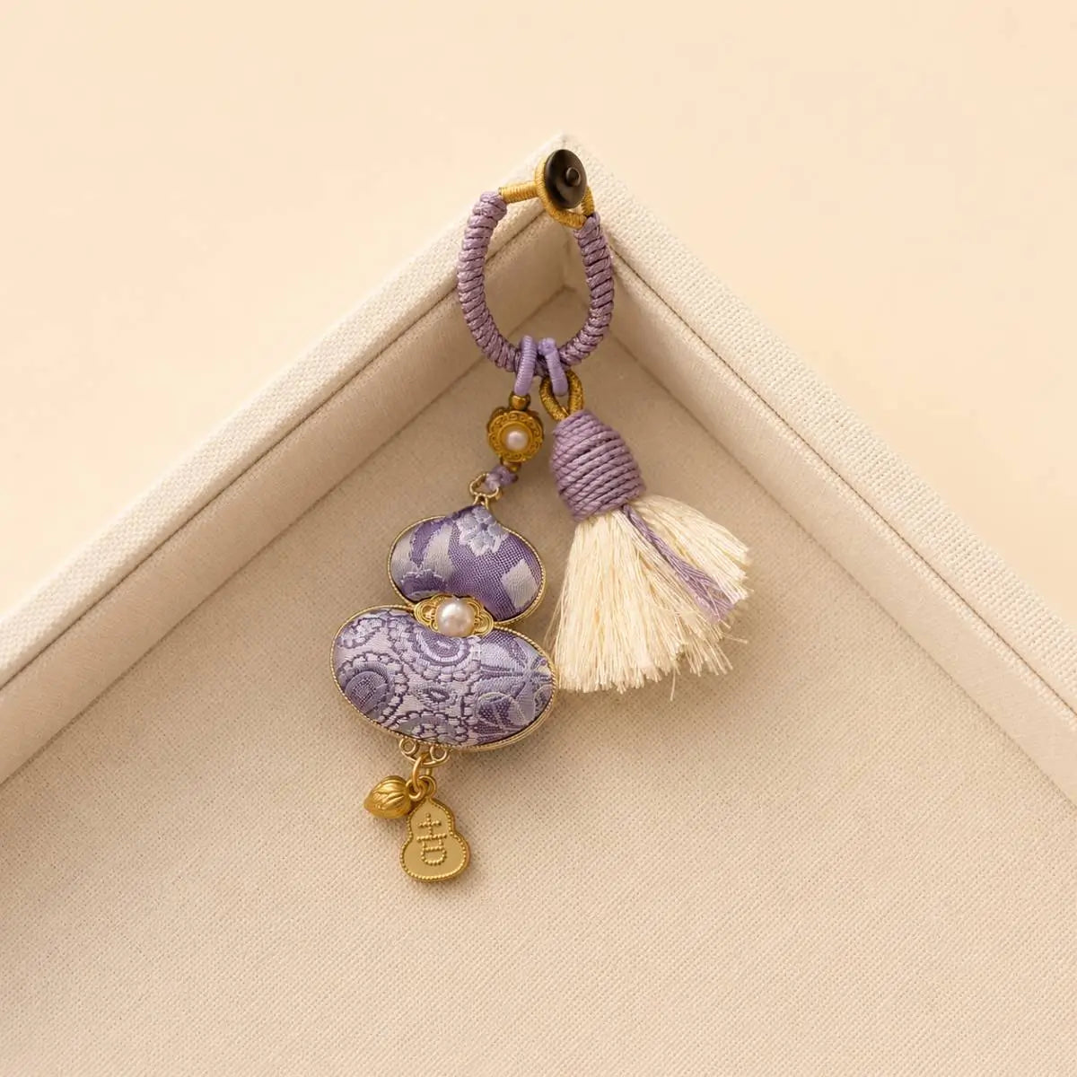 Purple handcrafted textile gourd bag charm with tassel detail