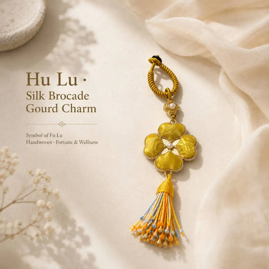 Handmade four-leaf clover bag charm with brocade-inspired fabric and tassel