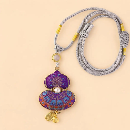 Purple Song Brocade gourd pendant necklace flat lay with woven cord