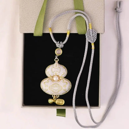 Elegant white and silver embroidered gourd necklace in a black gift box